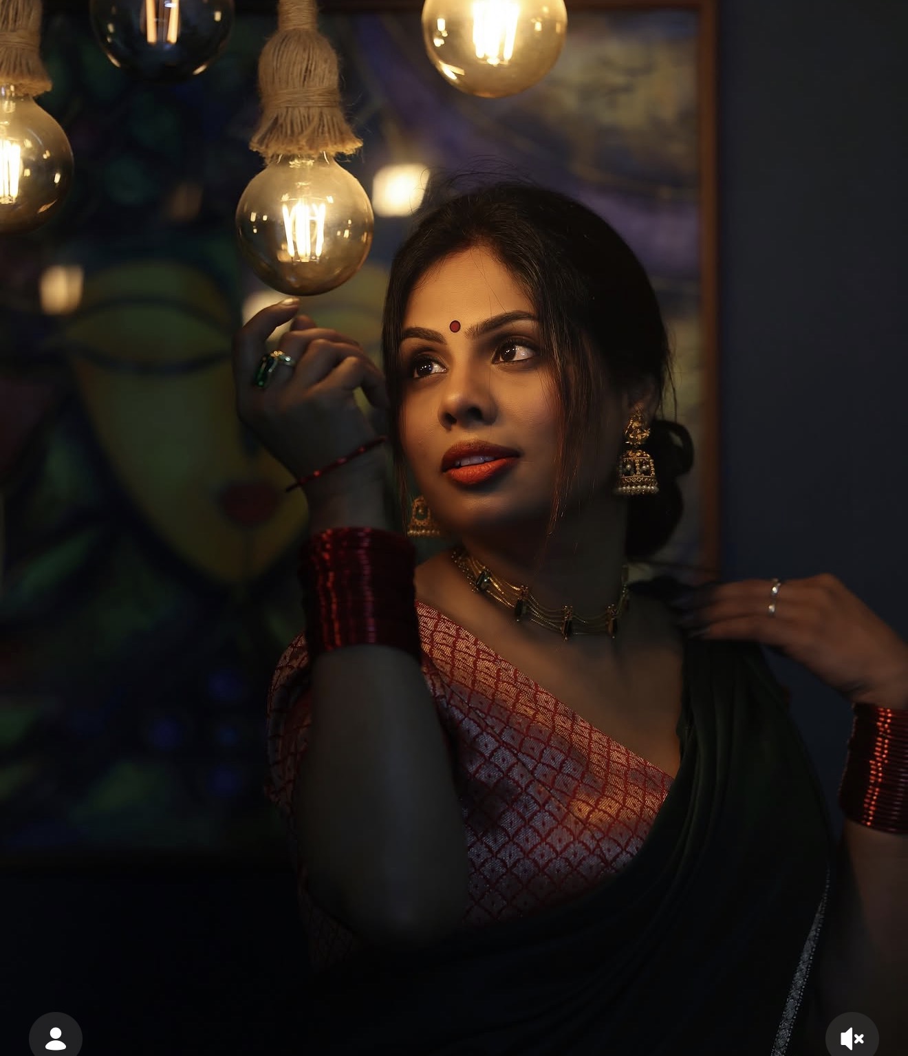 Cinematic portrait of Soumya beneath warm hanging lights in Dubai